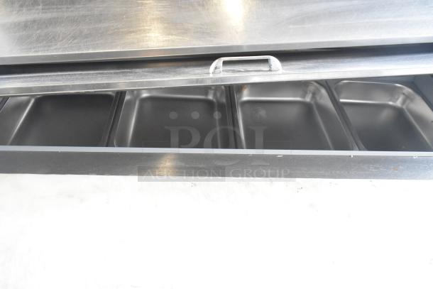 Beverage Air SPE48HC-12C prep table interior view, showcasing stainless steel pans. 115V, commercial use, on casters.