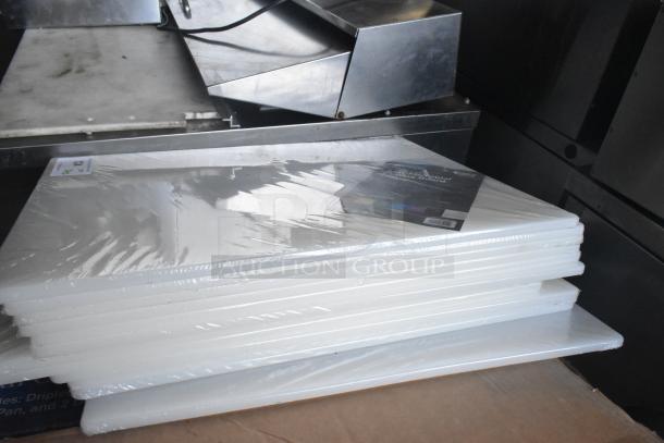 Set of 12 new Choice 40724185WH white polyethylene cutting boards, 24"x18"x1/2", with scratch and dent imperfections.