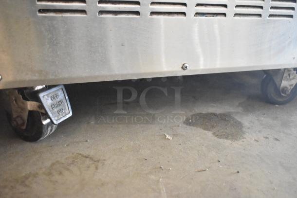 Glastender FRM-2 mobile ice cream freezer with 2 tub capacity, commercial casters, and brake on/off markings.