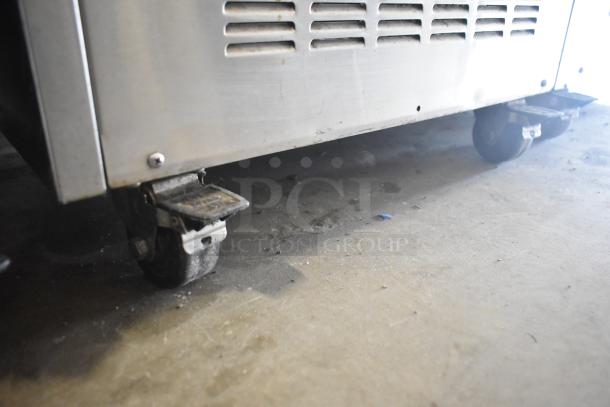 Glastender FRM-2 mobile ice cream freezer, 24" wide, on commercial casters. Features 2 tub capacity, 120 Volts, 1-phase.