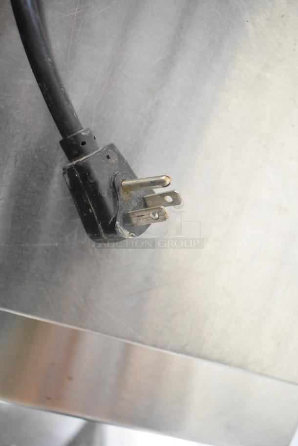 Black power plug of Glastender FRM-2 Commercial 24" Mobile Ice Cream Freezer on brushed metal surface.