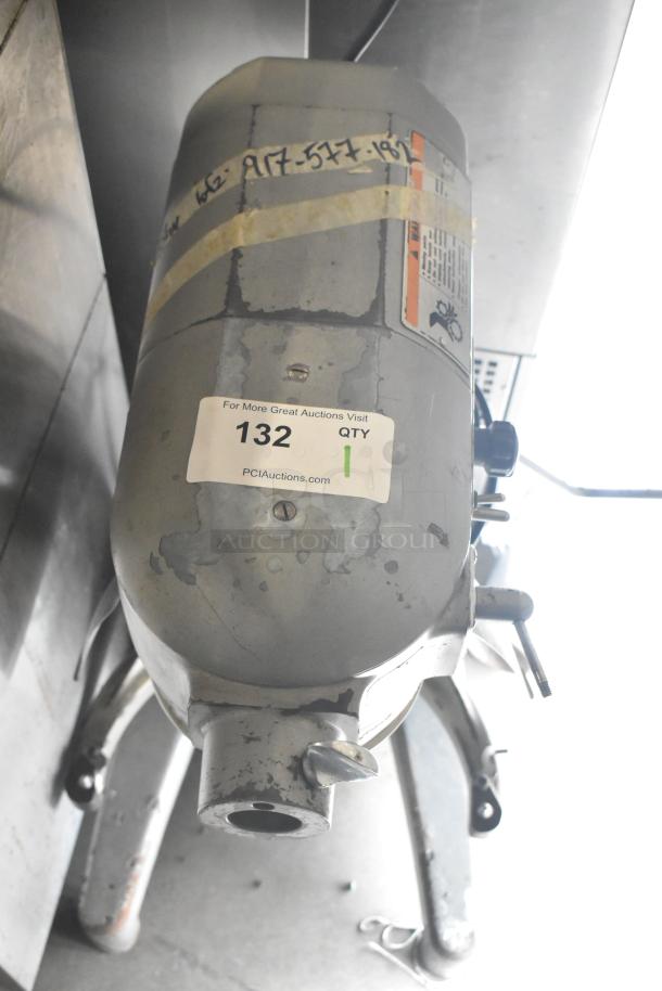 Hobart A200 commercial dough mixer, 115V, 1 phase. Visible scratches, labels indicating model and voltage specs.