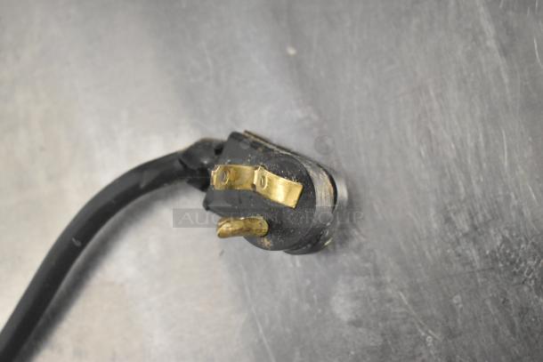 Power plug of True TBB-24-48G-SD-S-LD Commercial Back Bar Cooler, 115V, showing three-prong connection.