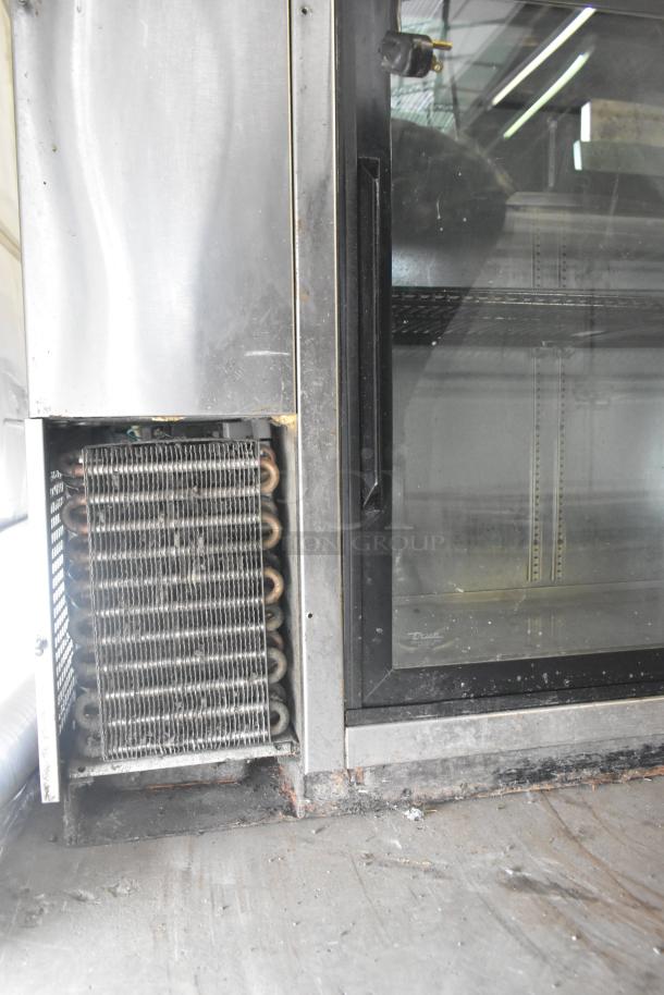 True TBB-24-48G-SD-S-LD 2-door back bar cooler, glass doors, stainless steel frame, visible cooling coils, commercial use.