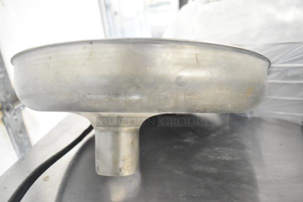 Metal meat grinder tray with circular design. Used condition with visible wear. Suitable for kitchen or culinary use.