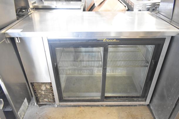 True TBB-24-48G-SD-S-LD 2-door back bar cooler, glass doors, 115V, commercial-grade, shelving visible, used condition.