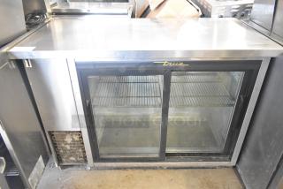 True TBB-24-48G-SD-S-LD 2-door back bar cooler, glass doors, 115V, commercial-grade, shelving visible, used condition.