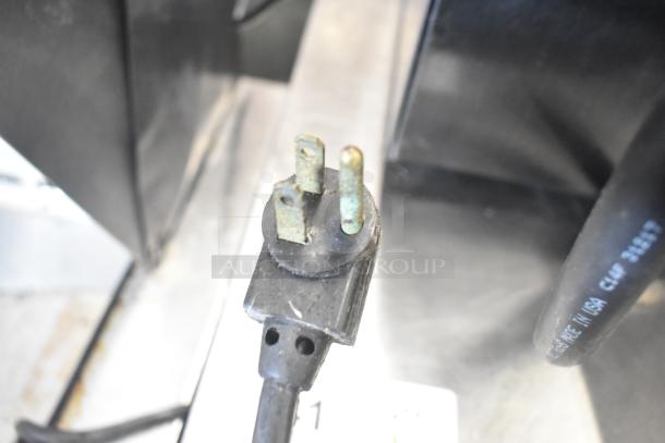 Close-up of a plug for the True TFP-48-18M-D-4 commercial salad prep table, showing signs of wear. 115V, 1 phase.
