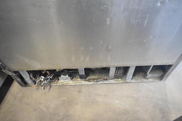 True TFP-48-18M-D-4 commercial prep table, 4 drawers, commercial casters, viewed from back, showing electrical components.