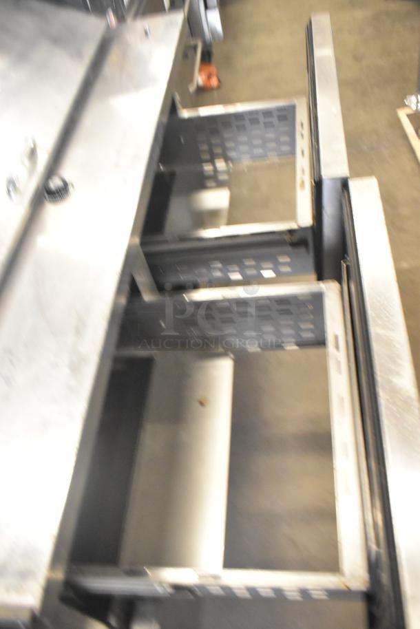 True TFP-48-18M-D-4 prep table with four open drawers. Commercial casters, 115V, 1 phase. Stainless steel exterior.