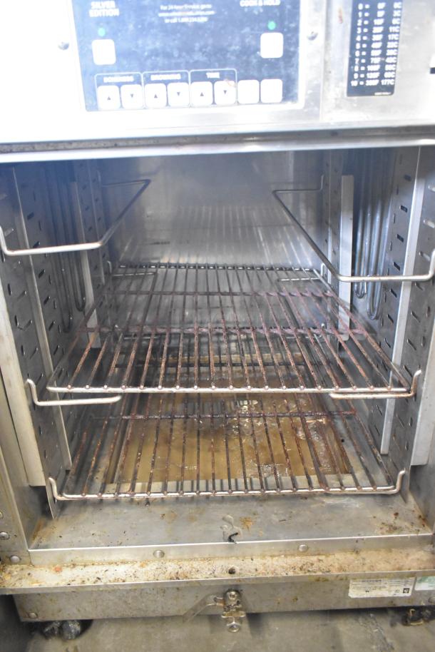 Winston CVap CAC509GR heated holding cabinet, 208V, 1-phase, on commercial casters, interior racks visible, used condition.