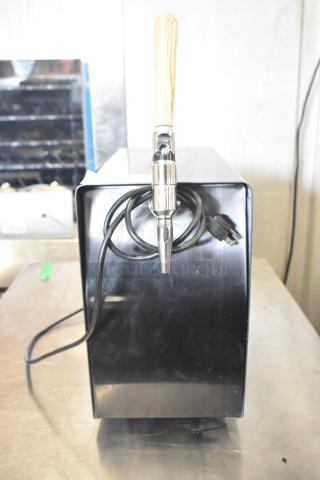 Countertop single tap shot dispenser, black finish, wood handle, 115 volts, 1 phase, plug attached, new condition.