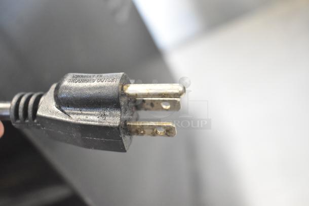 Countertop single tap shot dispenser plug, 115 volts, 1 phase. Plug shows slight wear, labeled for grounded outlet use.