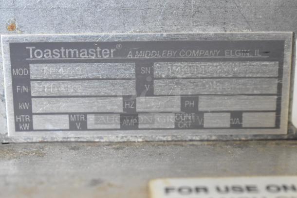 Toastmaster TP409 4-slot toaster label showing model and serial number details. 115 volts, 1 phase.