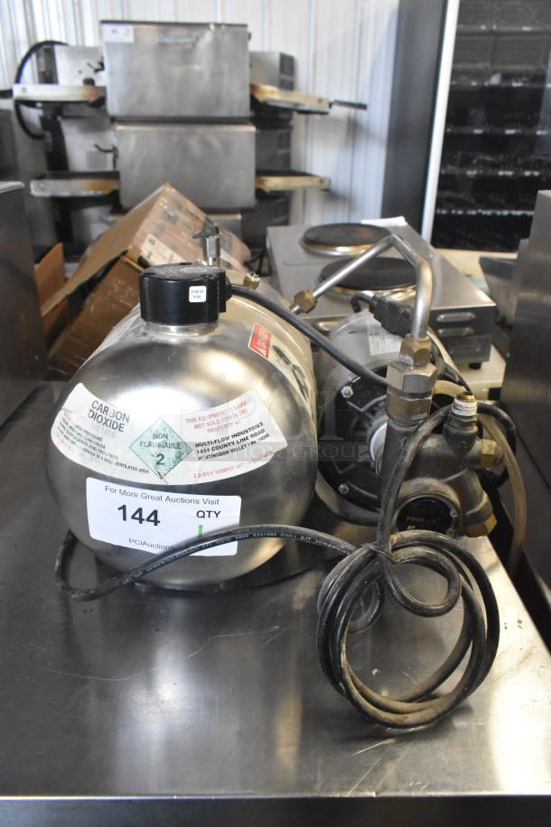 McCann's Motor, 115 Volts, 1 Phase, appears in used condition. Features labels indicating carbon dioxide content and safety warnings.