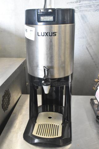 Fetco Luxus L3D-15 Beverage Holder Dispenser, stainless steel, used condition, visible spout, and digital display on the lid.