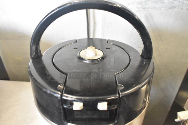 Fetco Luxus L3D-15 beverage holder dispenser, black lid, handle detail, used condition.