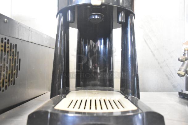 Fetco Luxus L3D-15 Beverage Holder Dispenser, black, visible drip tray, used condition.