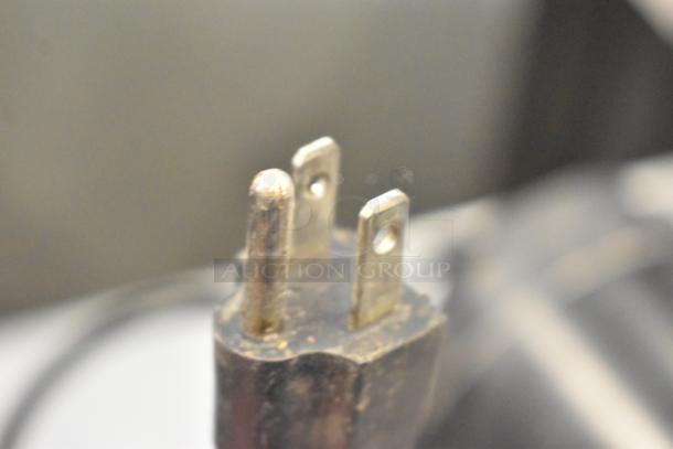McCann's Motor power plug, 115 Volt, 1 Phase, showing three metal prongs in used condition.