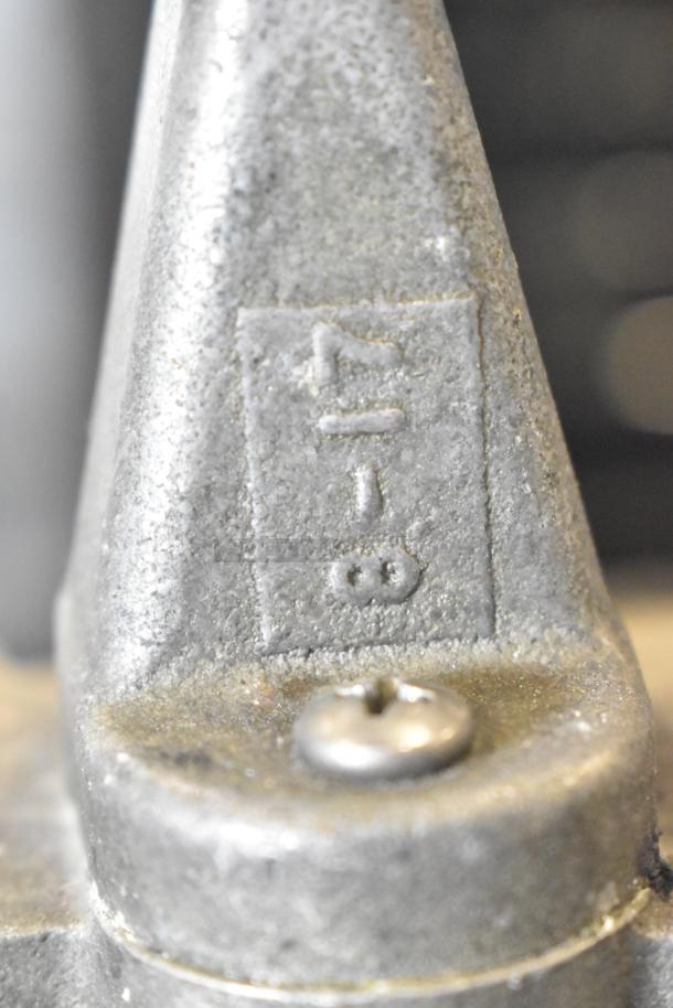 Nemco Countertop Vegetable Dicer, close-up of metal surface with stamped markings, indicating model details.