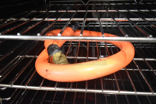 Southbend SLGS/12SG convection oven interior, featuring metal racks and an orange gas hose, in used condition.