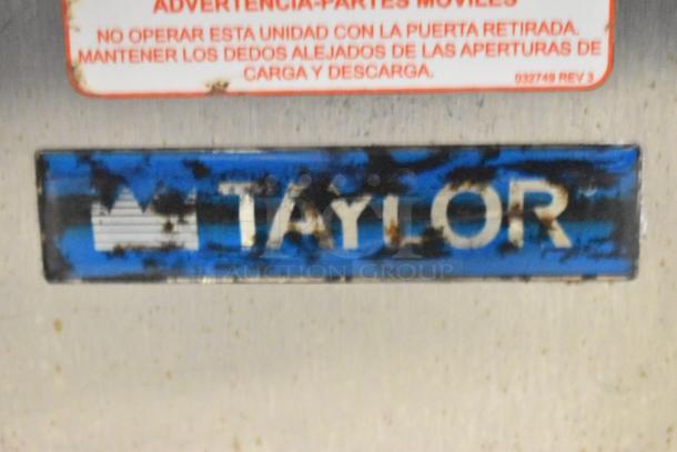 Taylor RD30-12 frozen drink machine with logo and warning label visible, showing signs of wear. 115V, 1 phase.