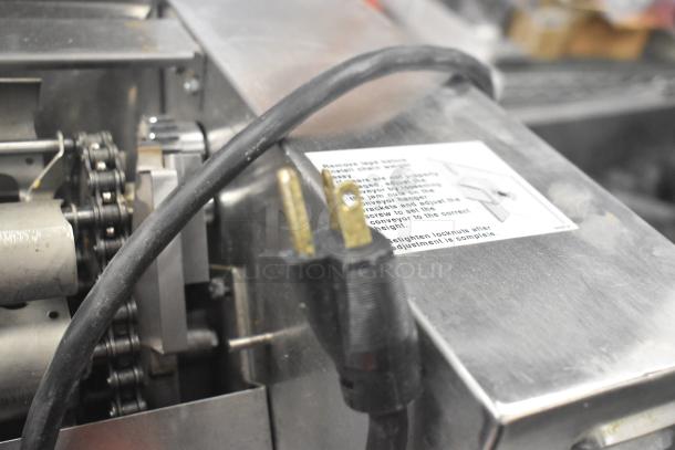 APW Wyott M-83 Commercial Bun Grill Toaster, 240V, visible plug, chain mechanism, and label instructions.