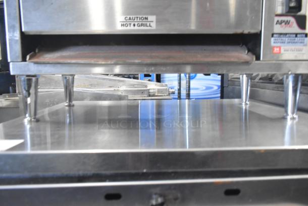 APW Wyott M-83 commercial vertical conveyor bun grill toaster, 240 volts, 1 phase, stainless steel, with caution label, excellent condition.