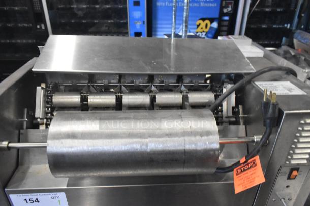 APW Wyott M-83 commercial vertical conveyor bun grill toaster, 240V, 1 phase. Features rotating rollers, stainless steel build.