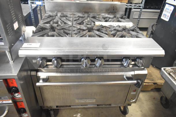 Vulcan V6B36S-502 commercial gas range with 6 burners, oven, and casters. Slight wear. Model label visible.