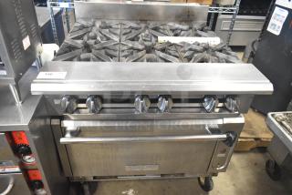 Vulcan V6B36S-502 commercial gas range with 6 burners, oven, and casters. Slight wear. Model label visible.