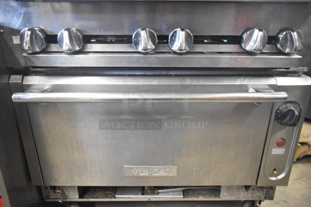 Vulcan V6B36S-502 commercial 6 burner gas range with oven, stainless steel, on casters, visible control knobs, used condition.
