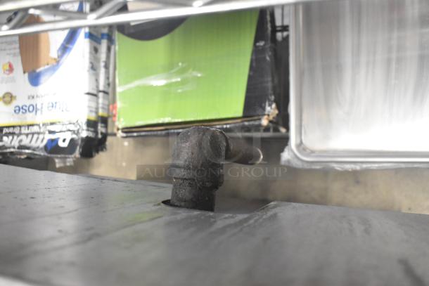 Vulcan V6B36S-502 Commercial Gas Range, 6 burners, oven, on commercial casters, showing gas connection pipe.