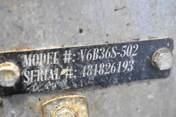 Metal plate showing Vulcan V6B36S-502 model and serial number 481826193 of a commercial gas range.