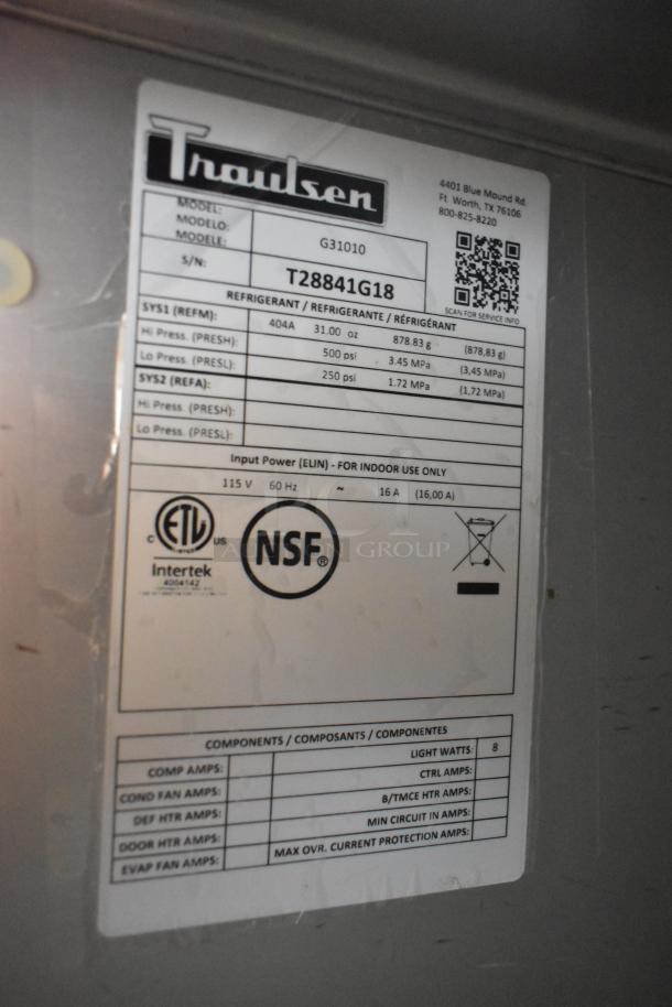 2018 Traulsen G31010 commercial 3-door reach-in freezer, on casters, label shows 115V, 1 phase, NSF certified.