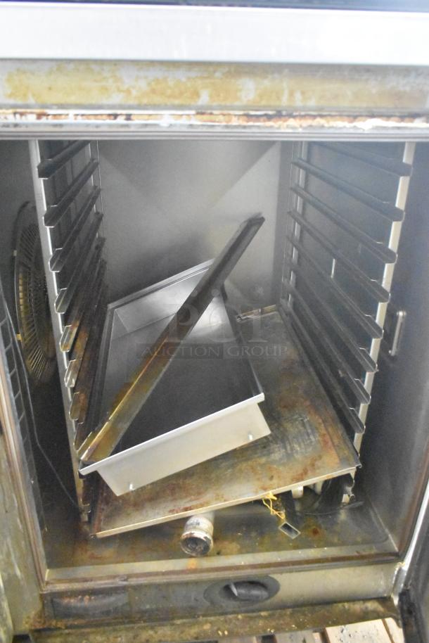 Rational SCCWE62/SCCWE102 stainless steel convection oven, visible tray and fan, on commercial casters, 480V, 3-phase.