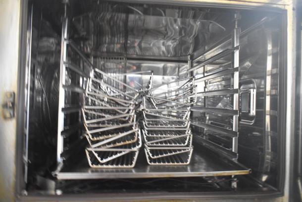 Rational SCCWE62/SCCWE102 stainless steel commercial convection oven interior with multiple racks, on commercial casters.