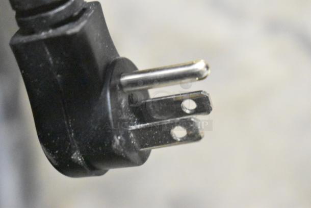 Close-up of a black three-prong electrical plug on a BRAND NEW 2024 Avantco 178GDC12FHCB merchandiser freezer.