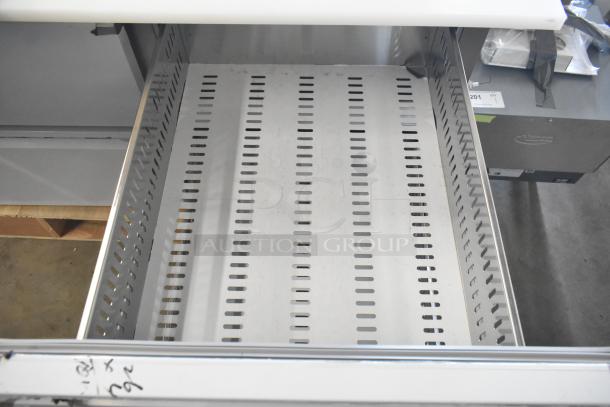 Brand new Avantco pizza prep table, 4 drawers, 1 door, 115V, scratch/dent condition, open drawer interior.
