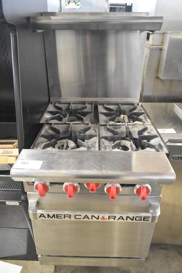 American Range commercial gas 4-burner range with oven, overshelf, and backsplash. Features red knobs, sturdy build, used condition.