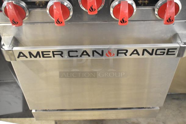 American Range 4 Burner Gas Range with oven, over shelf, and backsplash. Features durable knobs; good condition.