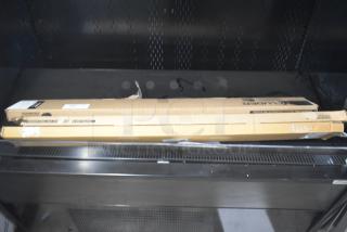 Three cardboard boxes containing 48" door sweeps, new condition, with visible product labels and packaging intact.