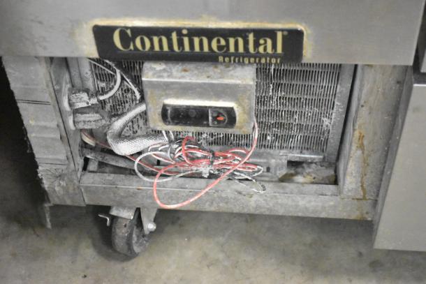 Continental CPA93 commercial pizza prep table with visible casters, wires, and branding, showing signs of wear. 115 Volts, 1 Phase.
