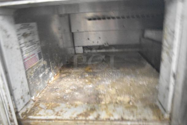 Continental CPA93 Commercial Pizza Prep Table interior, showing six drawers. Visible wear and dirt, on commercial casters.