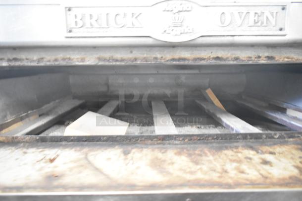 Two commercial single deck pizza ovens with "Brick Oven" branding, showing interior baking surfaces. Used condition.