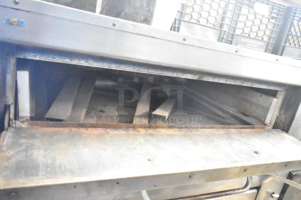 Montague 14-P-1 commercial pizza oven with cooking stones, natural gas powered, visible wear, open door view.