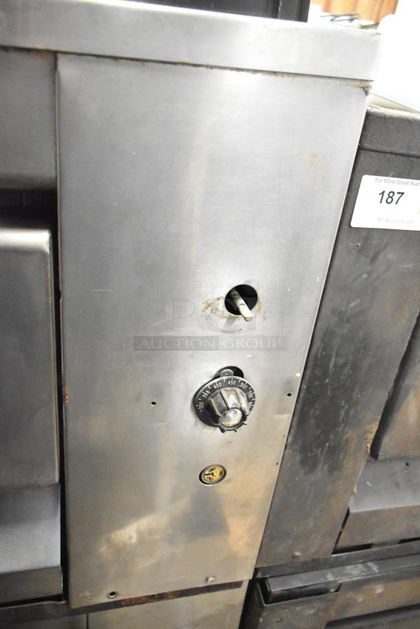 Two Montague 14-P-1 commercial natural gas pizza ovens with cooking stones, stainless steel exterior, visible temperature dial.