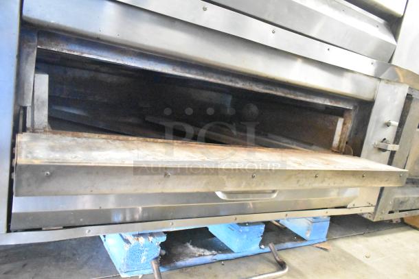 Montague 14-P-1 commercial pizza oven, natural gas, single deck, includes cooking stones, visible wear, no markings visible.