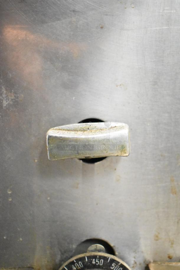 Montague 14-P-1 commercial pizza oven control knob with temperature dial, showing signs of wear.