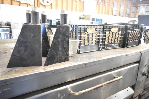 Montague 14-P-1 single deck pizza oven, natural gas, with cooking stones, shown in used condition with crates nearby.